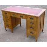 OAK DOUBLE PEDESTAL DESK WITH NINE DRAWERS AND ARTS AND CRAFTS HANDLES ON TAPERING LEGS AND