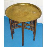 NEAR EASTERN CIRCULAR BRASS TABLE TOP WITH FOLDING LEGS (58 cm x 58 cm), A SMALL WOODEN OVAL SIDE