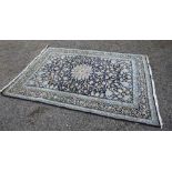 A PERSIAN CARPET, THE INDIGO FIELD WITH A CENTRAL ANCHOR MEDALLION AND ALL OVER STYLISED FLORAL