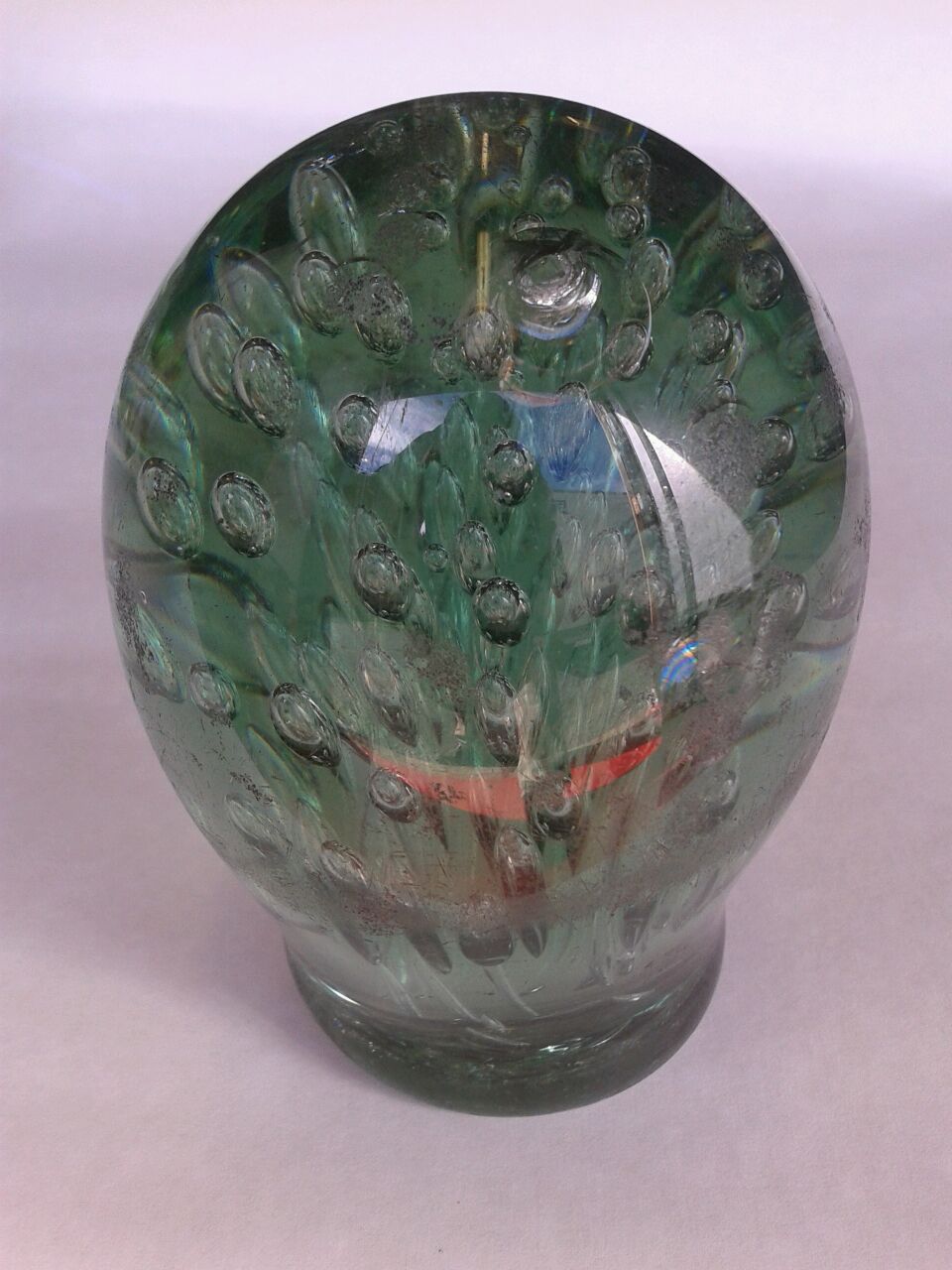 TWO VICTORIAN GREEN GLASS DUMPS WITH TAPERING BUBBLES/INCLUSIONS, A CLEAR GLASS DUMP WITH BLACK, RED