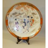 JAPANESE SAUCERDISH PAINTED WITH FIGURES IN A LANDSCAPE, SIGNED MEIJI PERIOD (DIA: 30 cm)