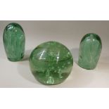 THREE VICTORIAN GREEN GLASS DUMPS TWO OF OVOID FORM WITH BUBBLES/INCLUSIONS AND A SPHERICAL DUMP