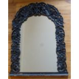 PAIR OF EASTERN TEAK ARCH TOPPED MIRRORS WITH CARVED AND PIERCED SCROLLING FRUITING VINE