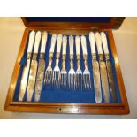 12 EARLY VICTORIAN MOTHER OF PEARL HANDLED DESSERT KNIVES AND 12 FORKS BY GILBERT, IN A MAHOGANY