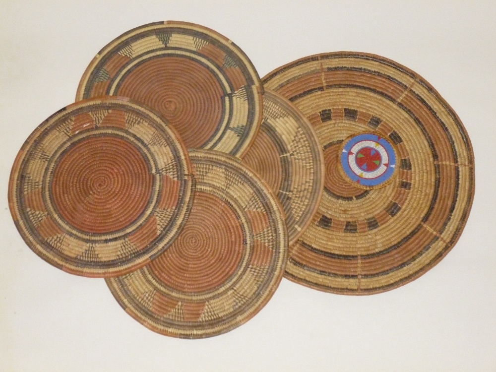 SIX WEST AFRICAN STRAW/GRASS MATS WITH DYED PATTERN (ONE WITH BEADWORK DESIGN), THREE WOVEN