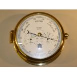 SEWILLS SHIPS BAROMETER WITH THERMOMETER AND HYGROMETER DIALS IN A BRASS CASE (DIA: 18 cm)