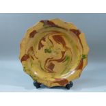 TERRACOTTA SHAPED CIRCULAR DISH WITH PAINTED BUTTERSCOTCH RED AND GREEN MARBLED DECORATION WITHIN