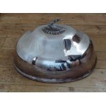 TWO SILVER PLATED OVAL DISH COVERS EACH WITH A DECORATED GAUNTLET AND DAGGER HANDLE (W: 45.3 cm &