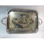 LARGE RECTANGULAR SILVER PLATED TRAY WITH FLOWER AND FOLIATE CORNERS AND HANDLES, A CENTRAL