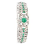 A bracelet with diamonds and emeralds in Art-Déco style Silver, marked 800. Setting with 53 emeralds
