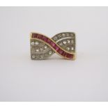 A RUBY AND DIAMOND RING designed as rows of pavé-set senaille-cut diamonds overlaid with a band of