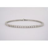 A DIAMOND BRACELET each circular four-claw link set with a round brilliant-cut diamond weighing