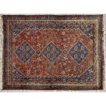 A SHIRAZ CARPET, SOUTH WEST, PERSIA the madder-red field with three dark blue diamond pole