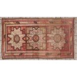 A DAGESTAN RUG,CAUCASIAN,CIRCA 1920 the red field with three geometric star medallions depicted in