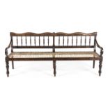 A CAPE STINKWOOD BENCH, 19TH CENTURY the shaped and carved top rail and curved mid-rail joined by