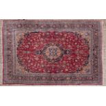 A KESHAN CARPET, PERSIA, MODERN the burgundy red field with a dark blue and pale brown floral