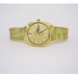 AN 18CT GOLD WRISTWATCH, OMEGA CONSTELLATION automatic, the circular textured gilt dial with black