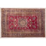 A MESHED CARPET, EAST PERSIA, MODERN the burgundy red field with a round indigo blue floral