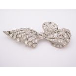 AN EDWARDIAN-STYLE DIAMOND BROOCH in the form of an open-worked bow, set throughout with old-cut