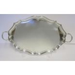 A GEORGE V SILVER TWO-HANDLED TRAY, ROBERT STEWART, LONDON, 1923 the shaped oval body with a