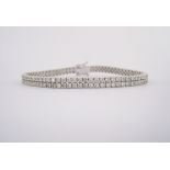 A DIAMOND BRACELET designed as a double row of claw-set round brilliant-cut diamonds weighing