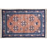 A CHINESE CARPET, MODERN the cinnamon field with five round skeleton medallions, blue floral