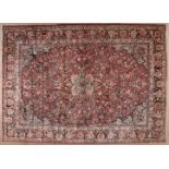 A SAROUK CARPET, PERSIA, CIRCA 1950 the terracotta field with a floral ivory and blue medallion,