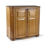 A CAPE STINKWOOD AND YELLOWWOOD CUPBOARD, 19TH CENTURY the shaped rectangular top above a pair of