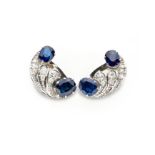 A PAIR OF SAPPHIRE AND DIAMOND EAR CLIPS each of C-scroll design, claw set with oval mixed-cut