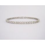 A DIAMOND BRACELET each link claw set with a round brilliant-cut diamond weighing approximately 8.
