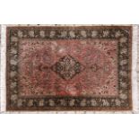 A QUM SILK RUG,PERSIA,MODERN the rose field with a dark indigo blue floral medallion and pendant,