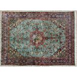 A TABRIZ CARPET, NORTH WEST PERSIA, MODERN the turquoise field with red pictures and a floral