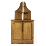 A CAPE YELLOWWOOD CORNER CUPBOARD, 20TH CENTURY in two parts, the triangular top surmounted by a