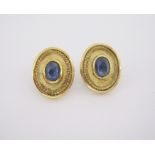 A PAIR OF SAPPHIRE EARRINGS each centred with an oval cabochon sapphire enclosed within a conforming