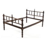 A CAPE STINKWOOD BED, 19TH CENTURY the turned head and footrail between ring-turned supports, on