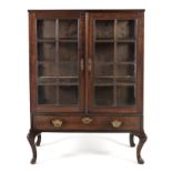 A CAPE STINKWOOD DISPLAY CABINET, 19TH CENTURY the rectangular top above a reeded frieze, a pair