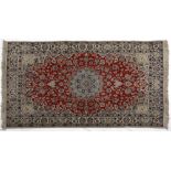 A Nain Rug, Persia, Modern the red field with a pale blue floral star medallion, ivory spandrels all