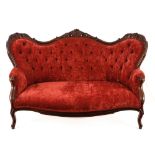 A Victorian mahogany two-ended settee, late 19th century the shaped top rail carved with crest and