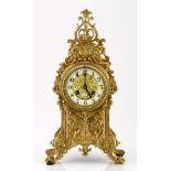 A FRENCH BRASS MANTLE CLOCK with an 11,5cm circular cream dial with black Arabic numerals, the