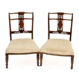 A pair of Victorian walnut and inlaid nursing chairs, late 19th century each with a turned top