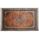 A fine Qum Silk Rug, Persia, Modern The cinnamon field with a dark blue and red floral star