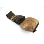 A bronze cow's bell, 19th century of typical form on a leather strap with pierced brass buckle 0 1