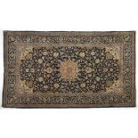 A Keshan Rug, Persia, Modern the deep indigo blue field with a floral ivory star medallion,