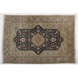 A Tabriz rug, Persia, Modern the dark blue field with an ivory floral medallion, ivory spandrels all