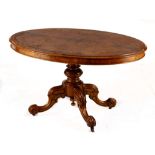 A Victorian burr walnut tilt-top centre table, late 19th century the oval quarter-veneered top