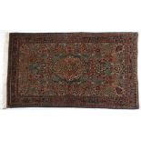 A Keshan Rug, Persia, circa 1960 the green field with a floral ivory medallion and pendant all
