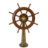 A British teak ship's wheel, with brass hydraulic column the 8-spoke wheel with heavy brass hub