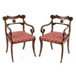 A pair of Regency style mahogany armchairs, 19th century each with a shaped top rail above a foliate