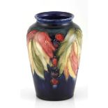 A Moorcroft 'Leaf and Berry' pattern vase, mid 20th century of tapering cylindrical form, painted