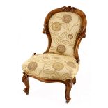 A Victorian walnut Grandmother chair, late 19th century the spoon-shaped back with an acanthus-